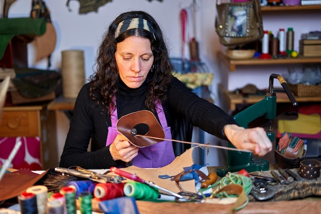 Craftswoman working leather