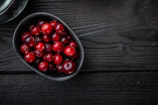 Cranberries on black wooden background