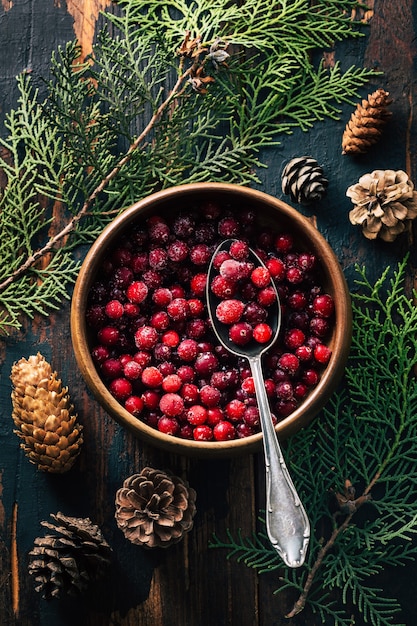 Cranberries in a plate on a wooden background. Copy space