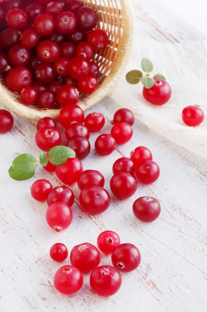 Cranberries scattered on a wooden table