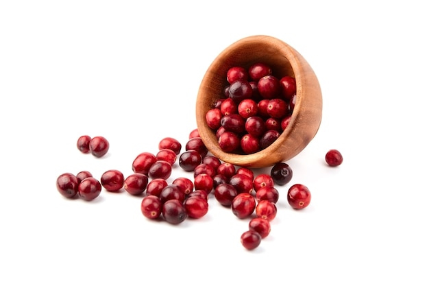 Cranberries in wooden bowl isolated on white