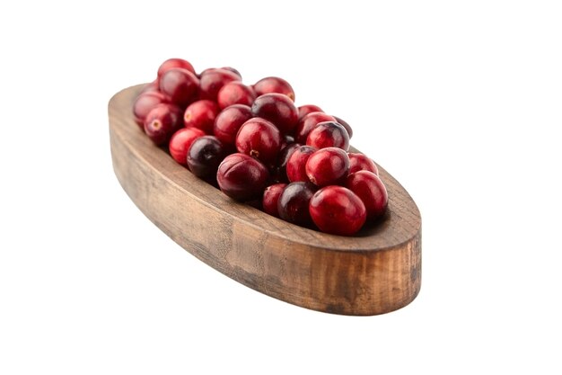 Cranberries in wooden bowl isolated on white