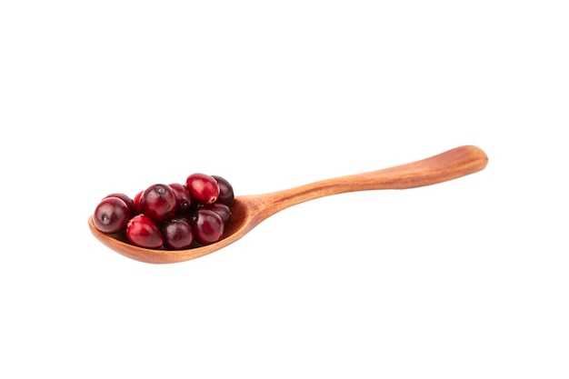 Cranberries in wooden spoon isolated on white