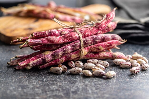 Cranberry beans Beans pods on a black table
