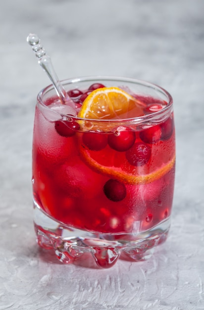 Cranberry cocktail with ice and orange