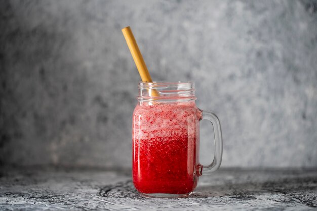 Cranberry and cowberry smoothie in mason jar with bamboo straw Refreshing summer fruit drink The concept of healthy eating Copy space