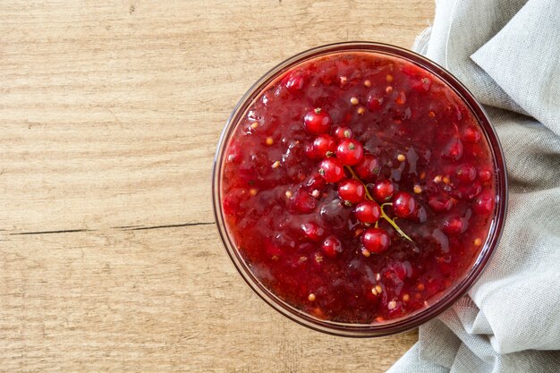 Cranberry sauce in bowl for Thanksgiving dinner on wooden table. Top view. 