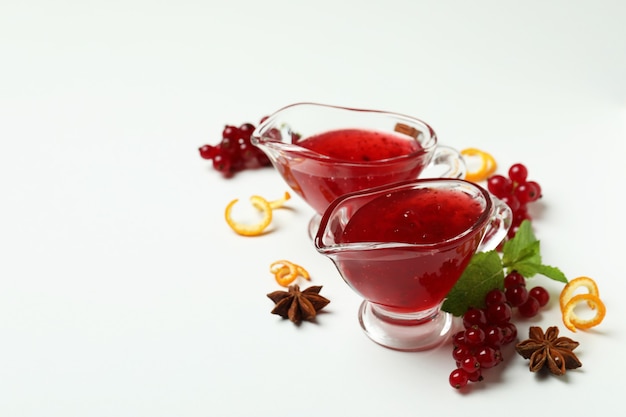 Cranberry sauce and ingredients on white background