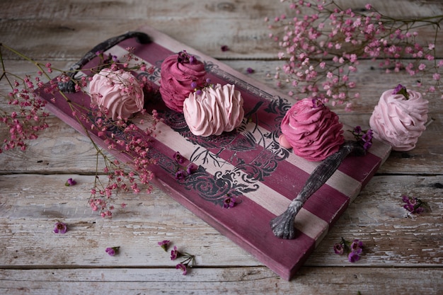 Cranberry and strawberry Russian marshmallows on vintage wooden feed board