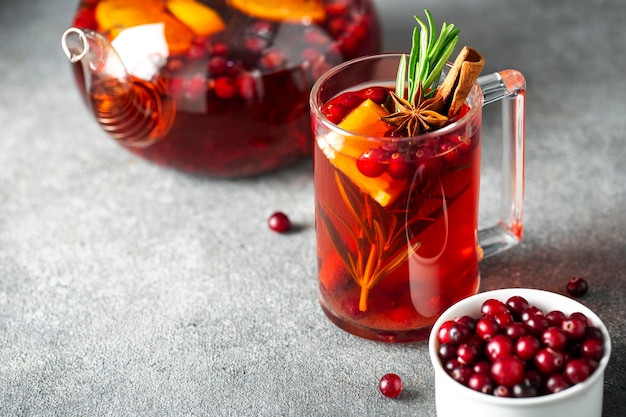 Cranberry tea, cinnamon , orange, rosemary, star anise and honey in a glass teapot