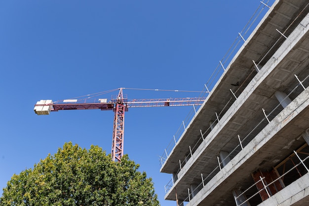 Crane and Apartment Building under construction. Construction site. Copy space