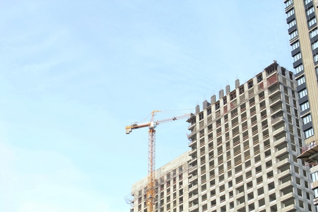 Crane and building construction site. Industry modern new civil house business. Concept of developme