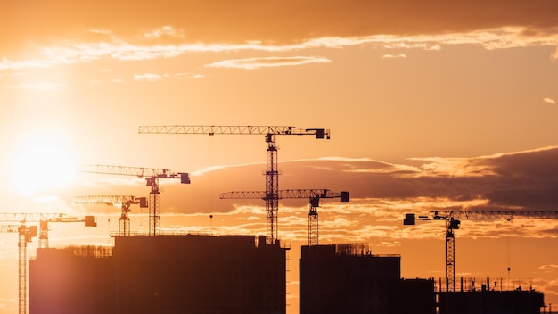 Crane and building silhouettes at sunrise