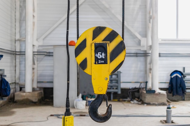 Photo crane chain and hook blurred warehouse background with remote control