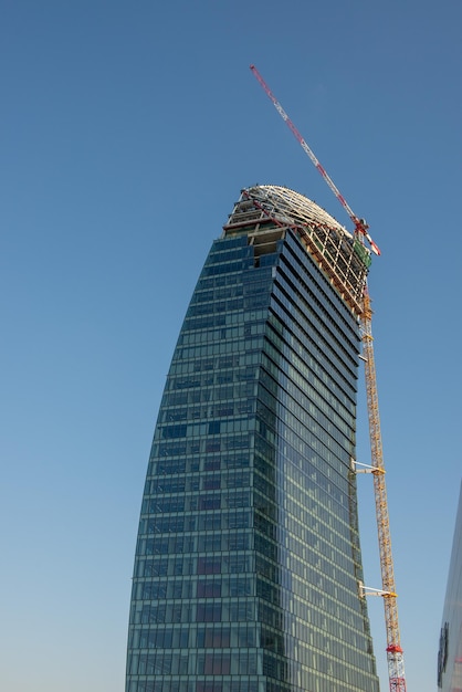 Crane completing the skyscraper La Torre Libeskind or Torre PwC which is part of the CityLife project