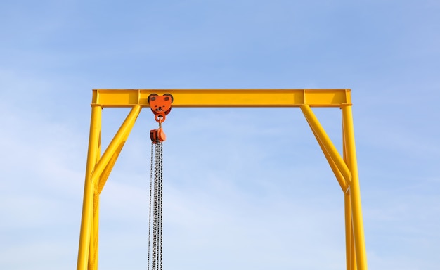 Crane for construction cradles against blue sky