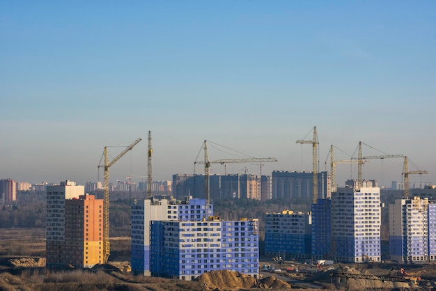 Crane and construction site against blue sky in the morning.