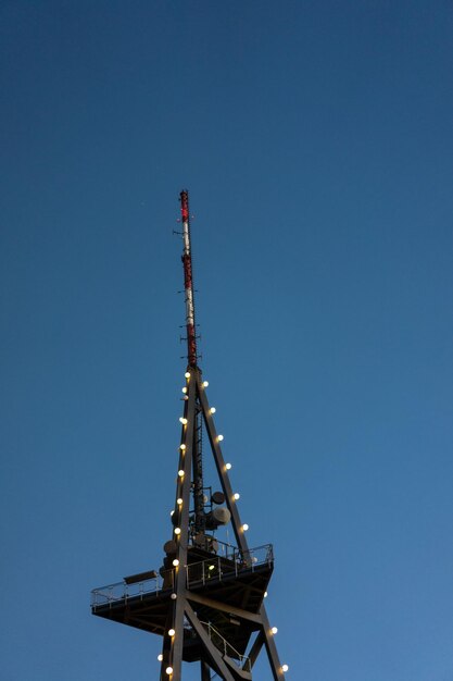 Crane at construction site against clear blue sky