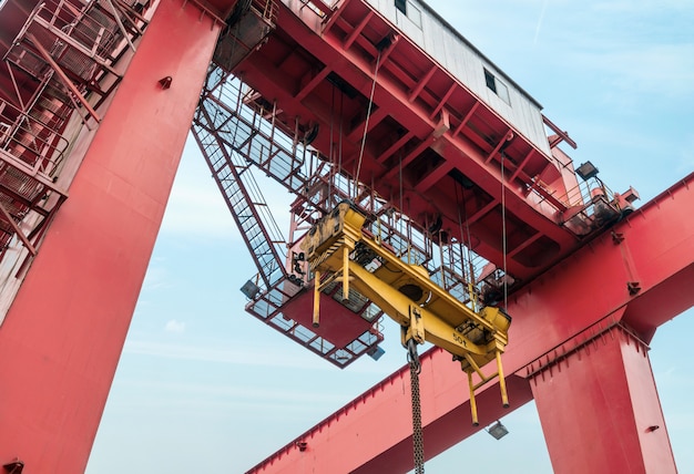 The crane is hoisting containers at the wharf