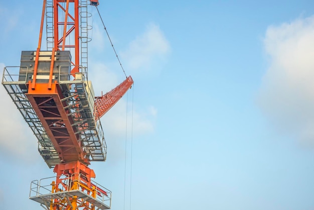 Crane lift orange in the blue sky