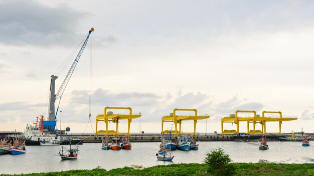 Crane for lifting a load up and down the ship in deep water harbor area of Thailand