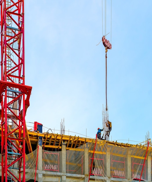 Photo crane and workers at construction of building