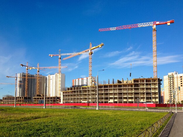 Cranes against blue sky