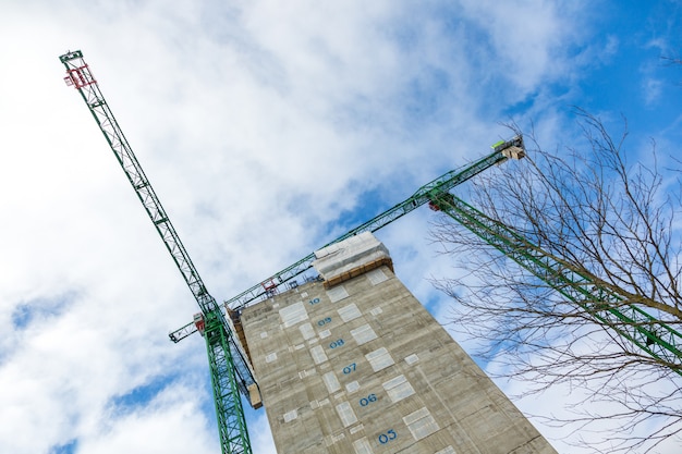 Cranes and new skyscraper on a building site in London