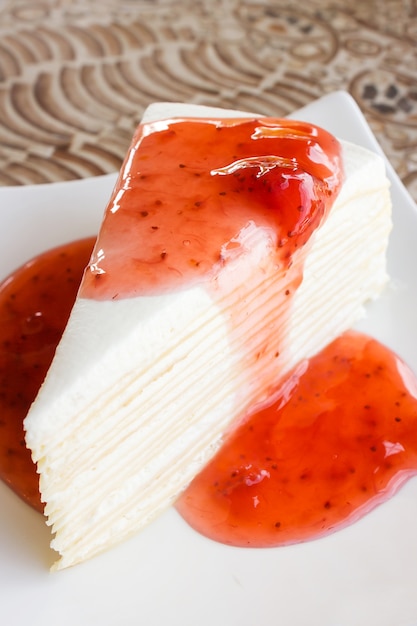 Crape cake with strawberry sauce.