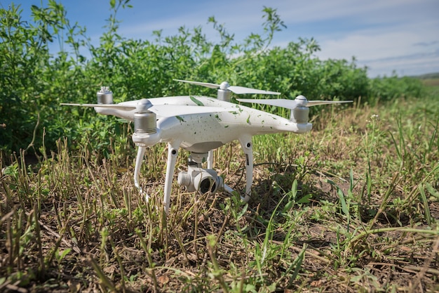 Crashed quadcopter in green grass