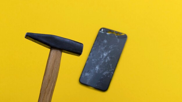 Crashed smartphone on a yellow background