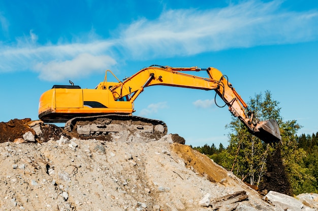 Crawler excavator front view digging on demolition site