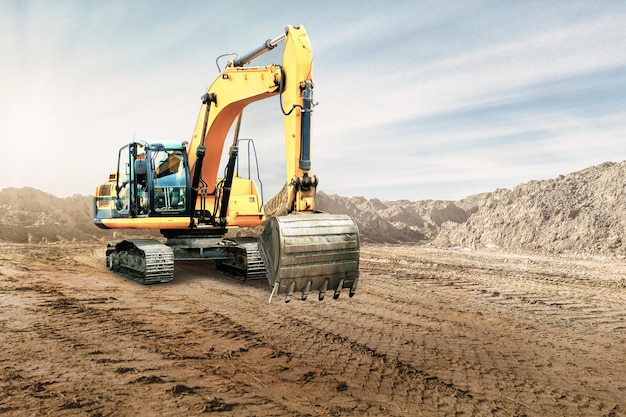 Crawler excavator works in a sand pit against the sky Powerful earthmoving equipment Excavation Construction site Rental of construction equipment