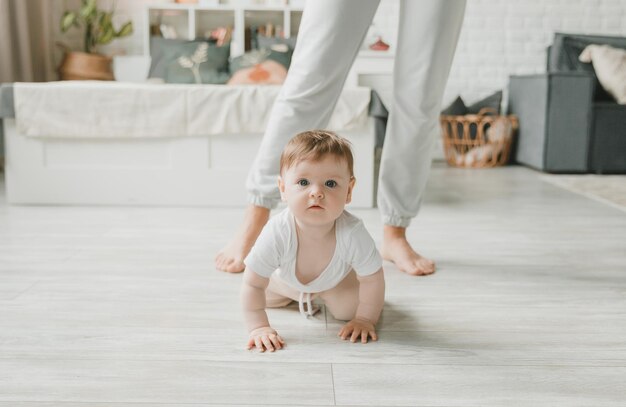 Crawling baby 6 months in the nursery at home