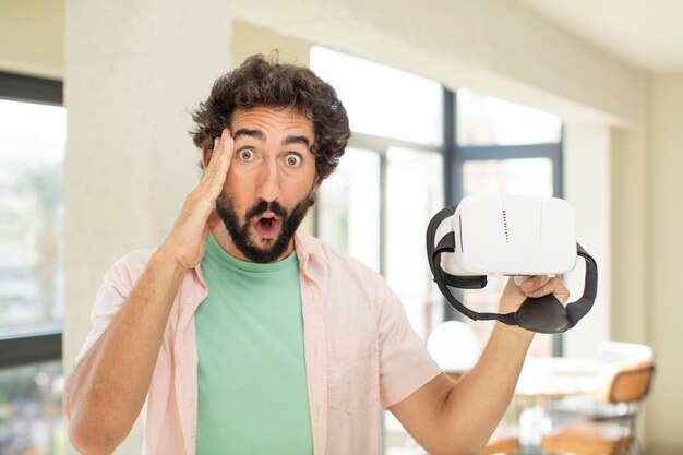 Photo crazy bearded man looking happy astonished and surprised vr goggles concept