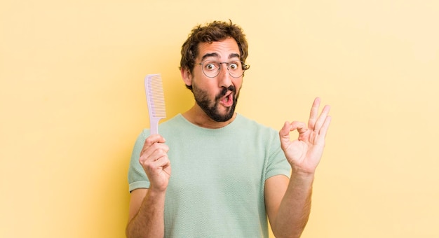 Crazy bearded man with a hair comb