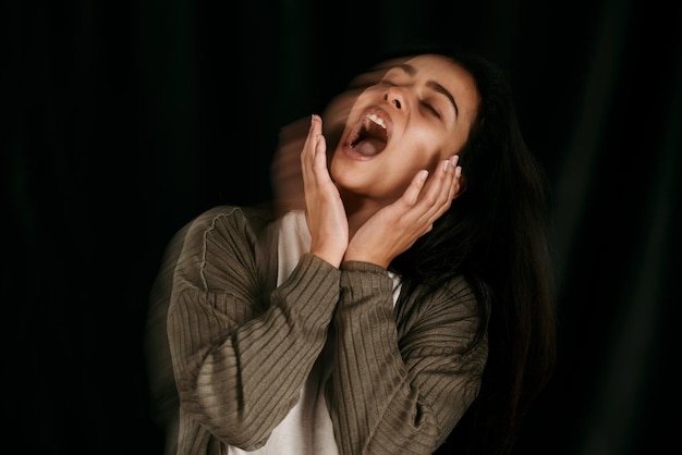 Crazy bipolar woman crying frustrated or anxiety on black studio mockup for psychology and mental health Trauma schizophrenia or depressed girl shout with depression fear and mental illness