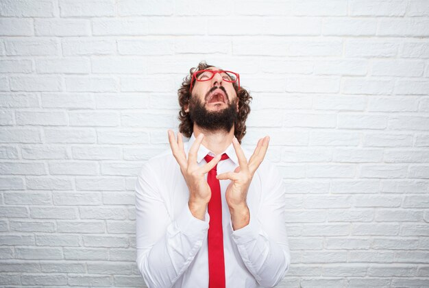 Crazy businessman expressing a concept. brick wall background