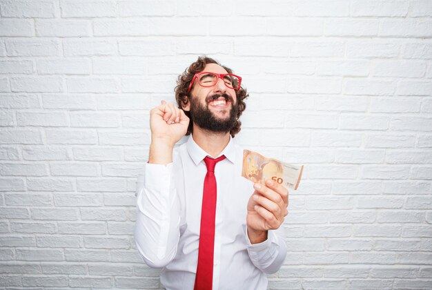 Crazy businessman expressing a concept. brick wall background