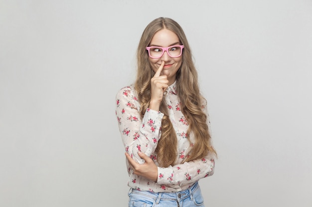 Crazy and comic concept. Funny woman touching nose and have a happiness look. Studio shot