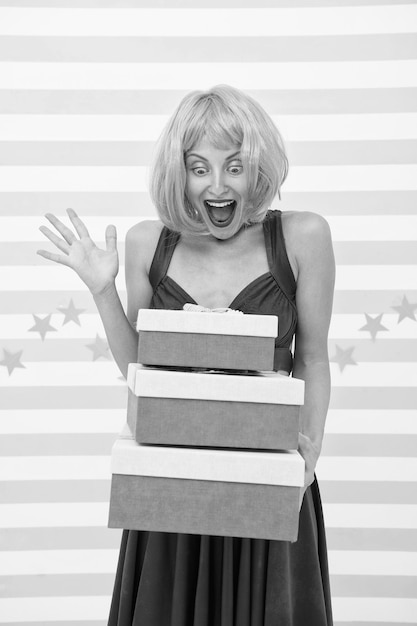 crazy girl with present boxes happy girl chooses which box to open first happy with surprise she is crazy about presents