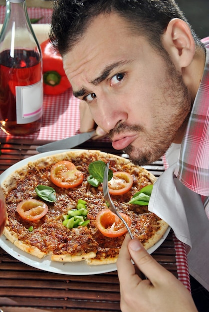 Crazy hungry man eating pizza in a restaurant