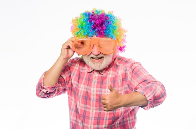 Crazy idea happy birthday corporate party anniversary holiday happy man with beard Celebration retirement mature bearded man in colorful wig and party glasses Crazy man in playful mood