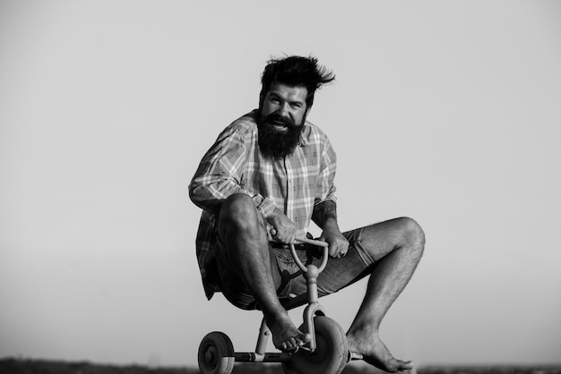 Crazy man bicyclist riding three wheeled bicycle