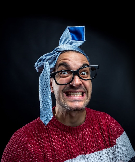 Crazy man with tie on his head  having fun on corporate party. Office and corporate party concept.