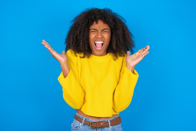 Crazy outraged Woman screams loudly and gestures angrily yells furiously