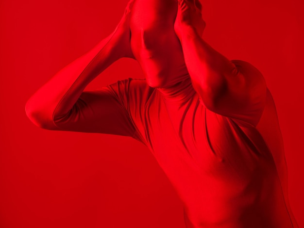 Crazy screaming red man on a red background figure in a leotard