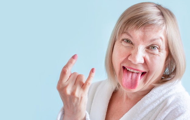 Crazy senior woman Anti age concept funky tongue out. Old age in joy, about seniority, cutie grandmother, healthcare, cosmetology, pensioner and mature people, new senior