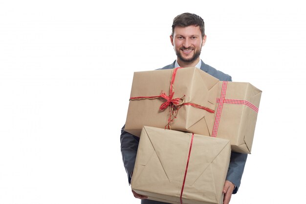 Crazy shopping on Valentines. Handsome bearded young man smiling warmly to camera posing with gifts.