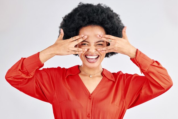 Photo crazy smile and portrait of a black woman on a studio background for funny comic and laughing happy excited and a young african model or corporate employee with a hand gesture by the face